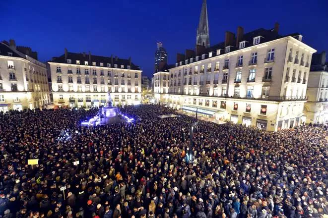 TOPSHOTSpeople gather at the Place Royale in Nantes on January 7, 2015, to show their solidarity for the victims of the attack by unknown gunmen on the offices of the satirical weekly, Charlie Hebdo. Heavily armed gunmen massacred 12 people on Wednesday after bursting into the Paris offices of a satirical weekly that had long outraged Muslims with controversial cartoons of the prophet Mohammed. AFP PHOTO GEORGES GOBET