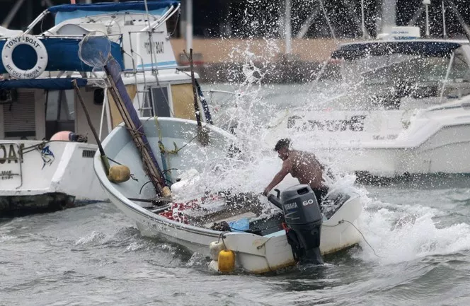TOPSHOTSA man tries to control a boat during tropical storm Carlos in Acapulco, Guerrero State, Mexico on June 14, 2015. Carlos gathered hurricane strength off the Mexican Pacific coast Saturday, as it threatened to lash the region with heavy rain. AFP PHOTO / Pedro Pardo
