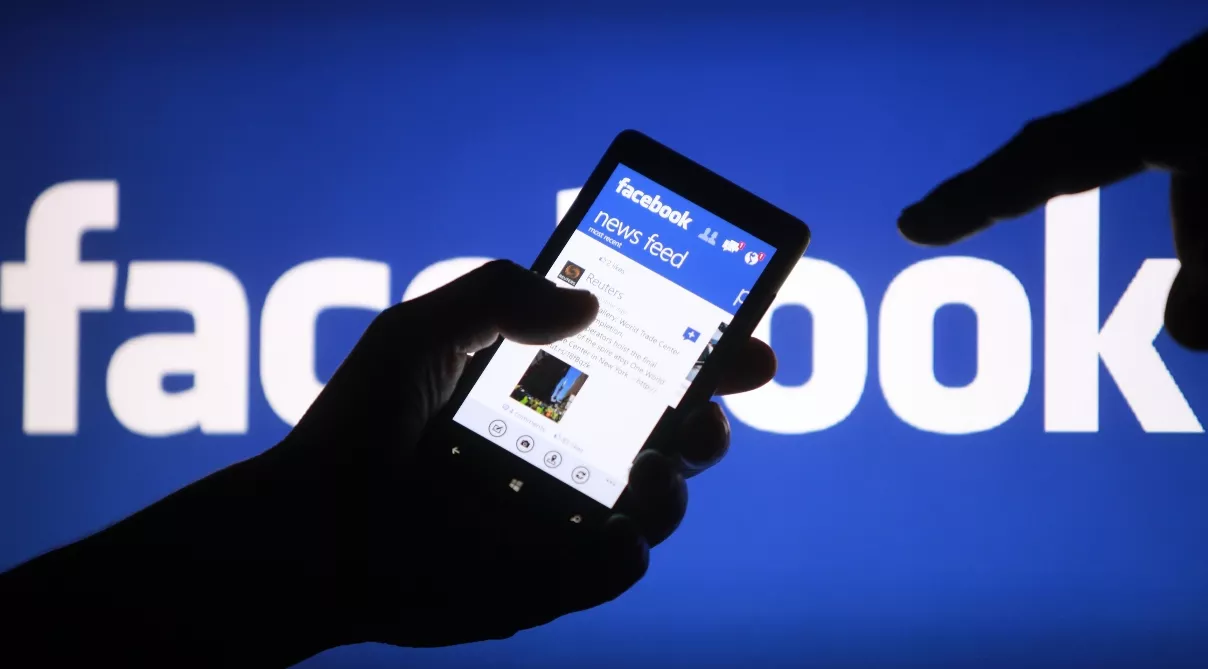 A smartphone user shows the Facebook application on his phone in Zenica, in this photo illustration