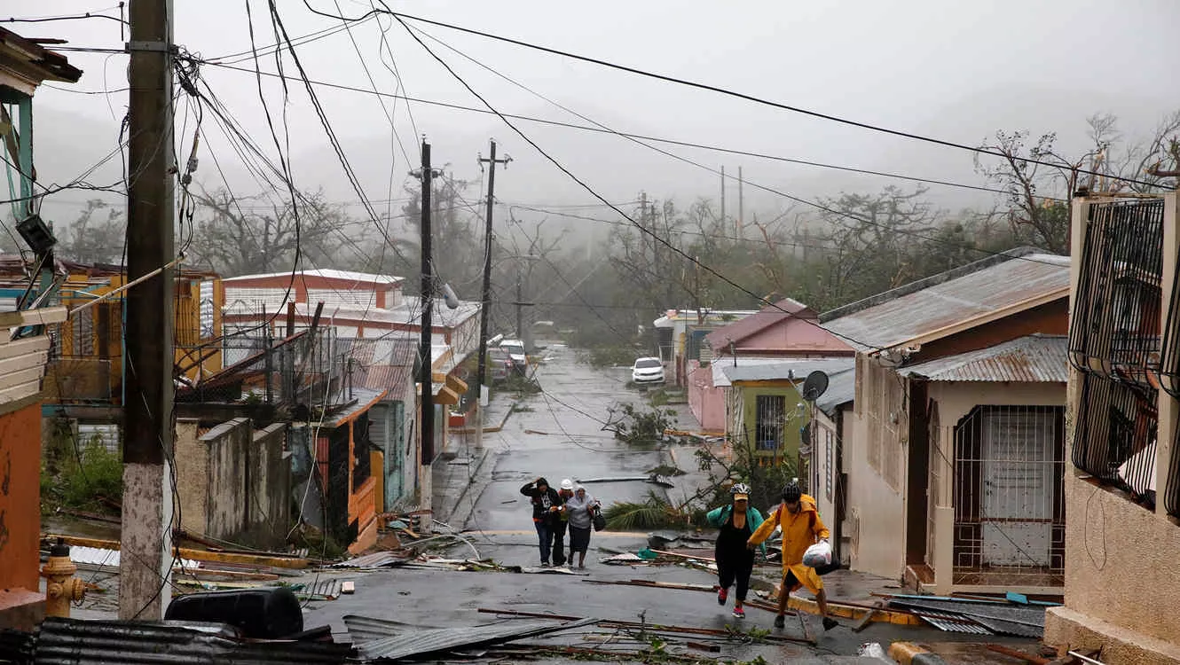 Rescue workers help people after the area was hit by Hurricane Maria in Guayama