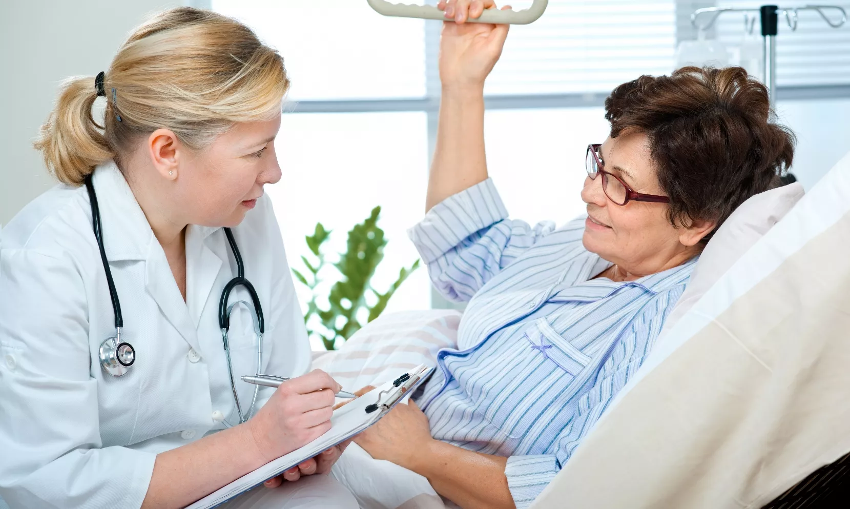 doctor or nurse talking to patient in hospital