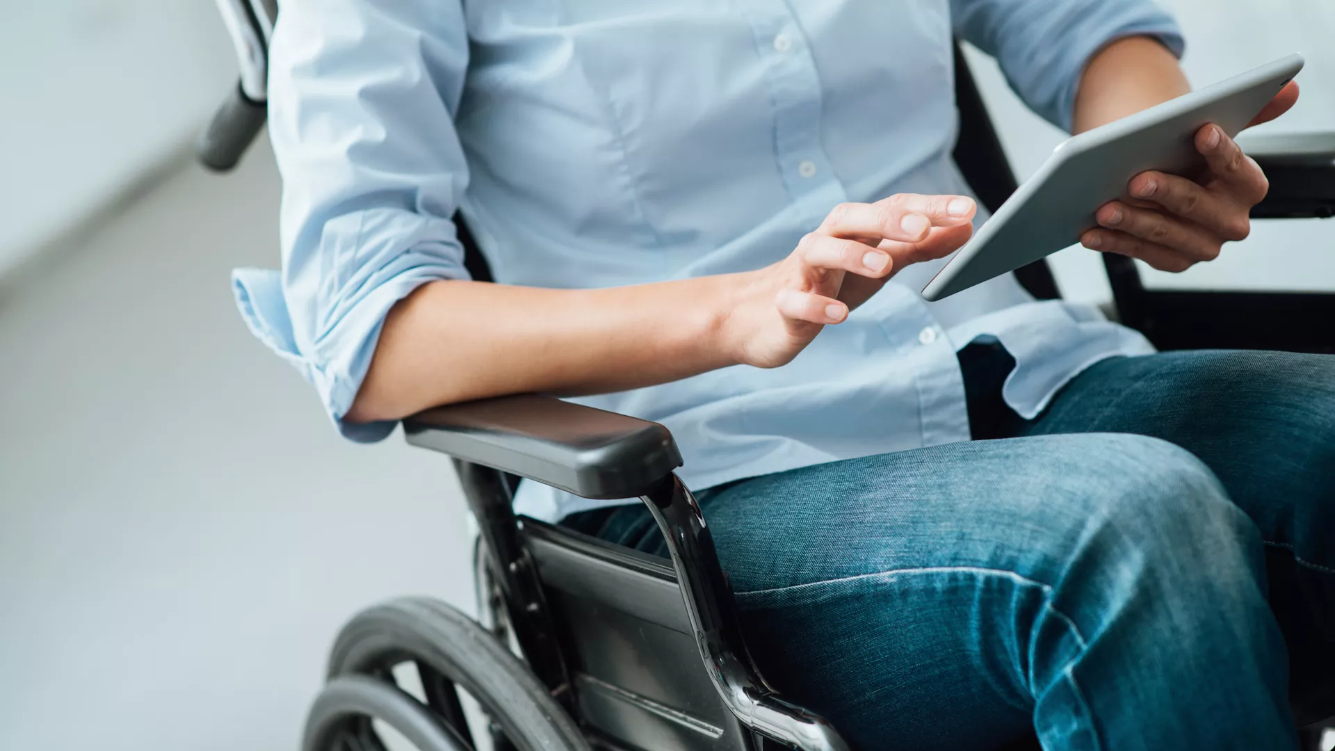 Woman in wheelchair using a tablet