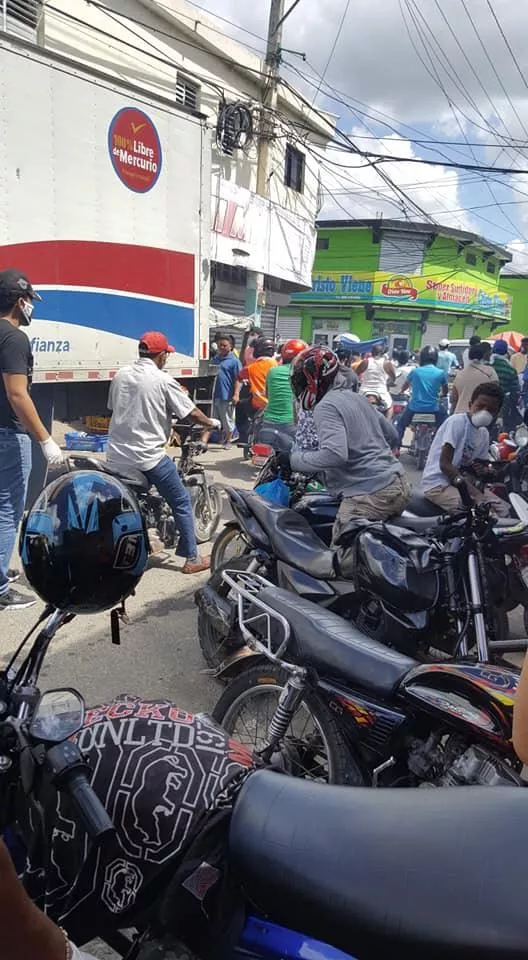 En Andrés, Boca Chica, decenas de personas esperaban a que abrieran los negocios de venta de comida para abastecerse.
