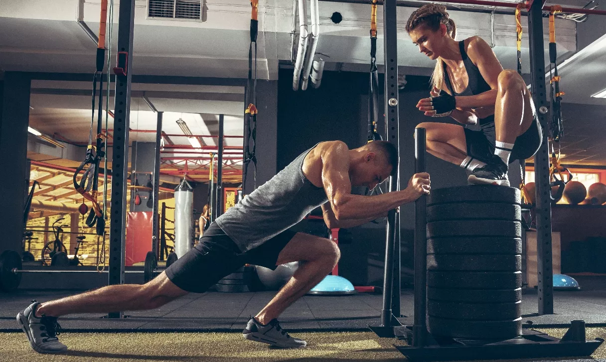 Athletic man and woman with a dumbbells
