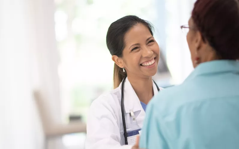 An Elderly Woman in Her Doctors Office Receiving a Check-Up stock photo