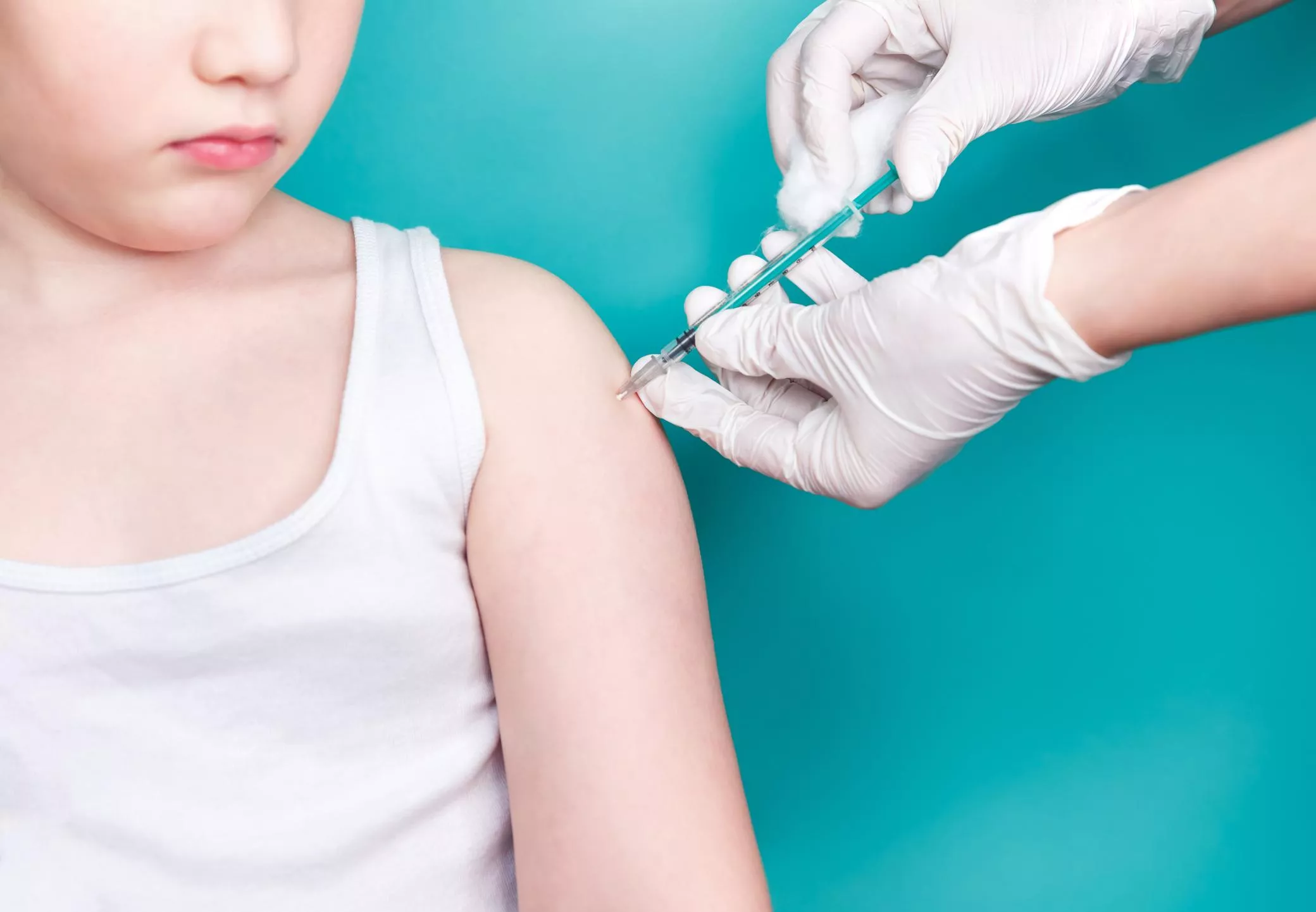 Doctor makes vaccination to a child. Inoculation in the shoulder