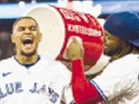 Vlad Guerrero Jr. le echa la cubeta a Santiago Espinal.  Ap
