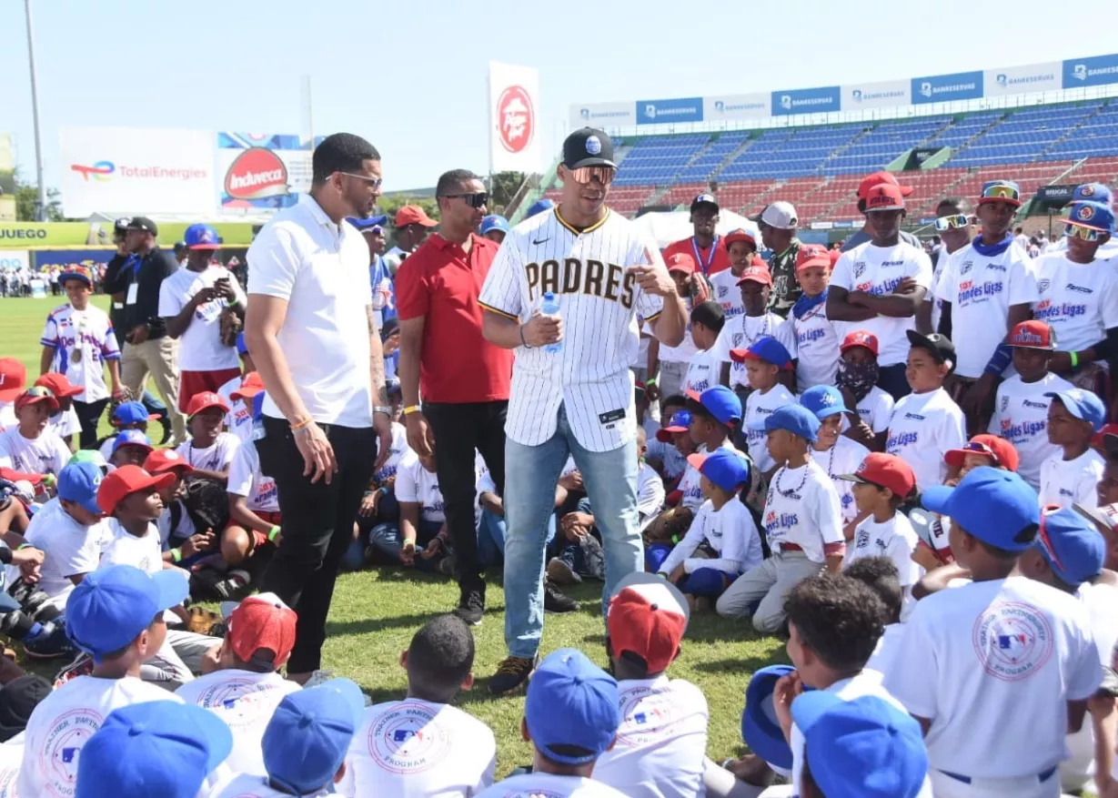 Los jugadores Juan Soto y José Sirí instruyen a los niños en el terreno.  Alberto Calvo.