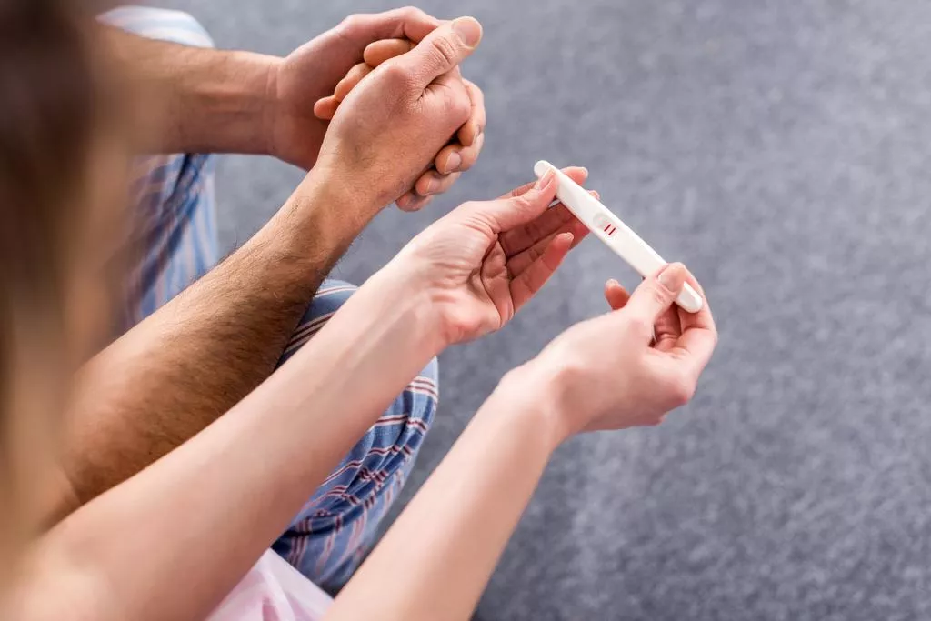 stock-photo-partial-view-couple-pregnancy-test