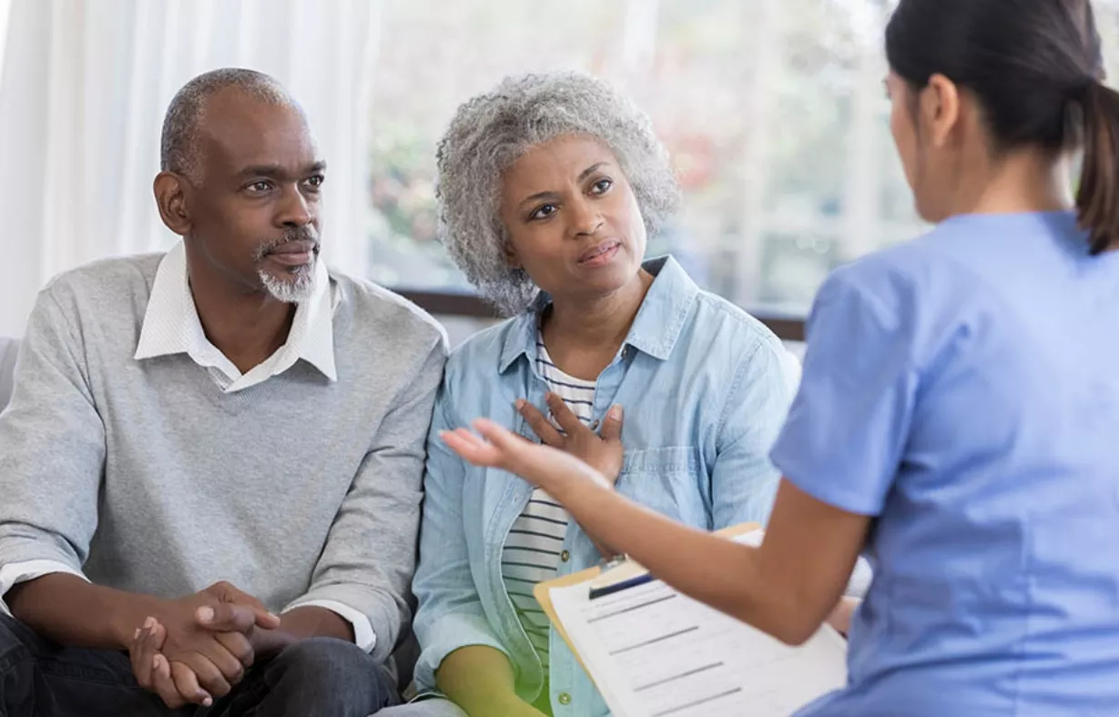 Doctor discusses health concerns with senior couple