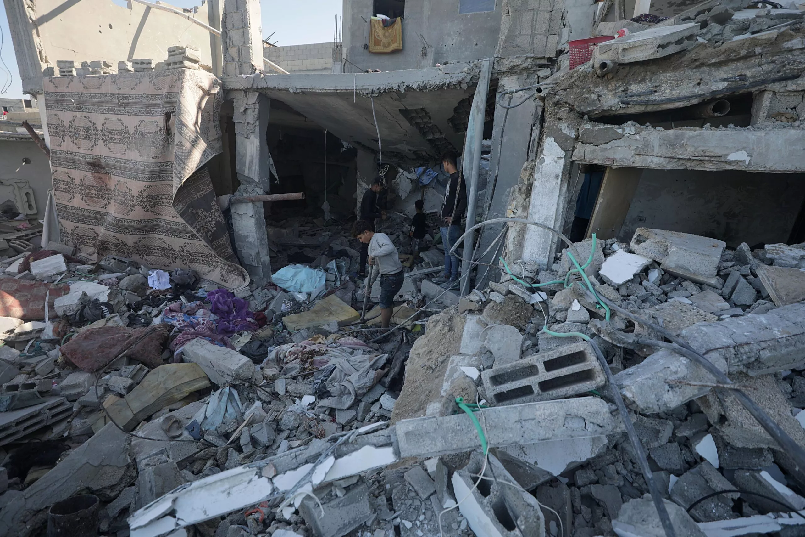 Palestinians inspect destroyed house following Israeli air strike in Deir al Balah, Gaza Strip
