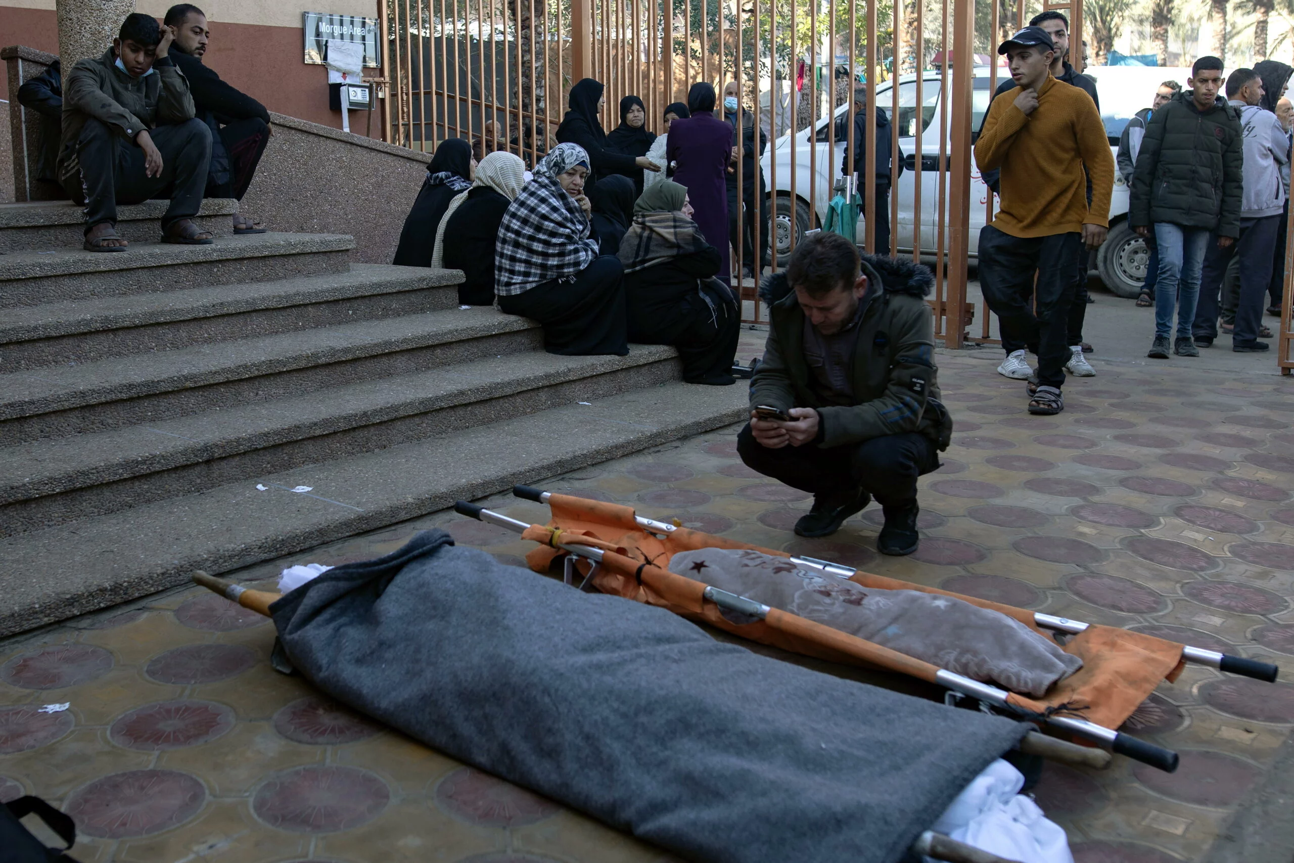 Relatives mourn over the remains of family members killed in Israeli air strike