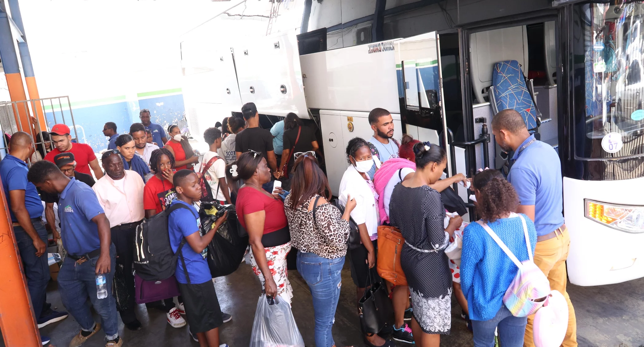 Pasajeros que se dirigían ayer hacia la provincia Barahona  en momentos en que abordaban el autobús para disfrutar del asueto junto a familiares.  Duany Núñez
