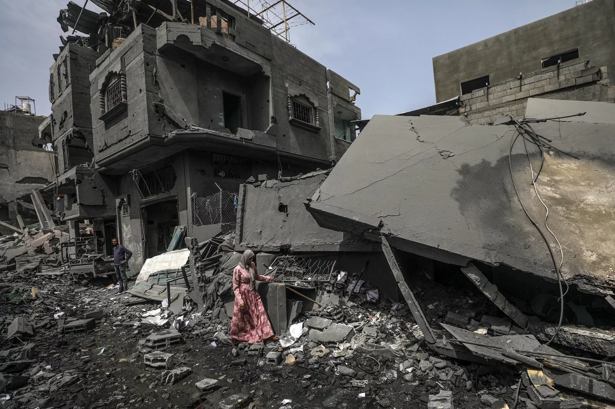 Palestinians assess damages after Isareli strikes at Al Maghazi Camp in Gaza strip