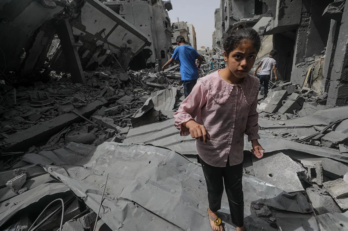 Palestinians assess damages after Isareli strikes at Al Maghazi Camp in Gaza strip