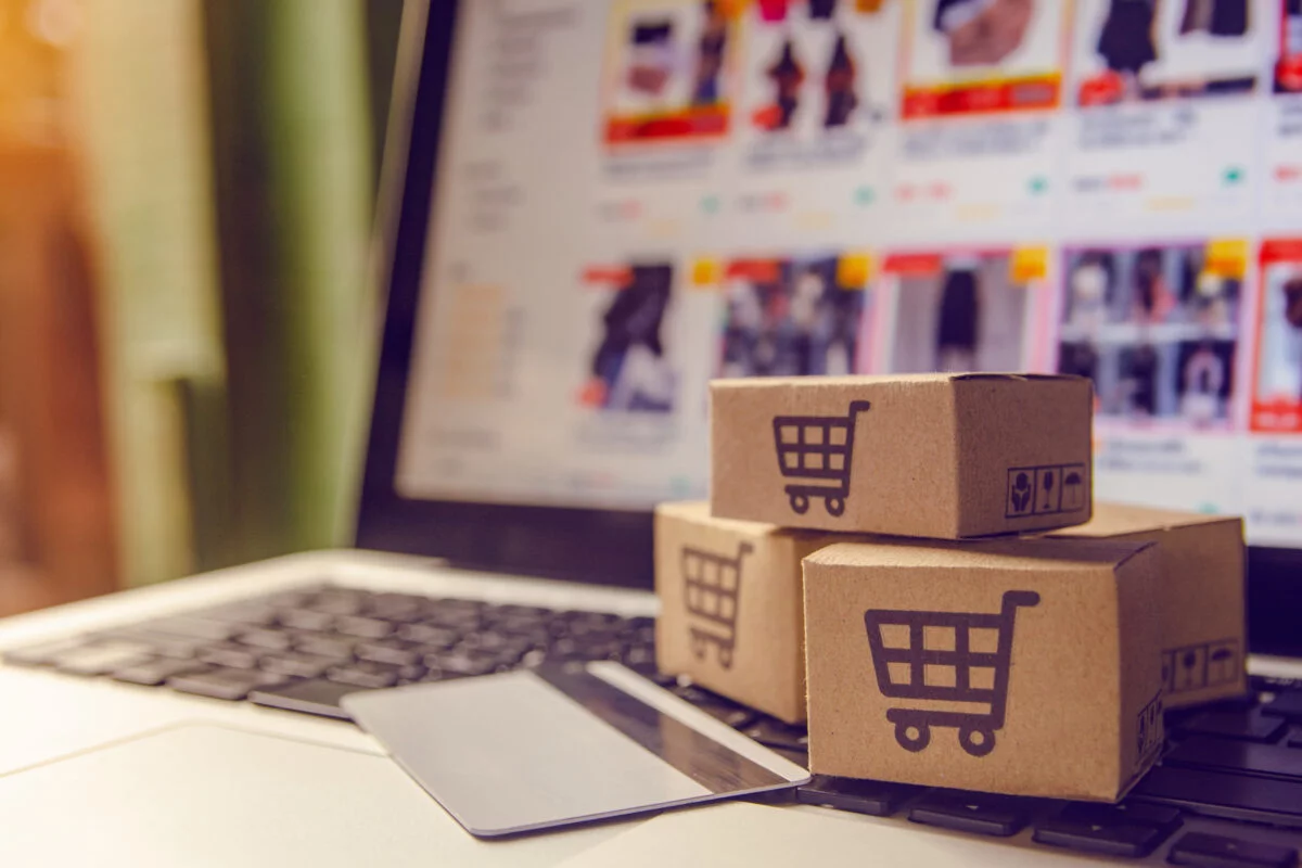 Shopping online concept – Shopping service on The online web. with payment by credit card and offers home delivery. parcel or Paper cartons with a shopping cart logo on a laptop keyboard